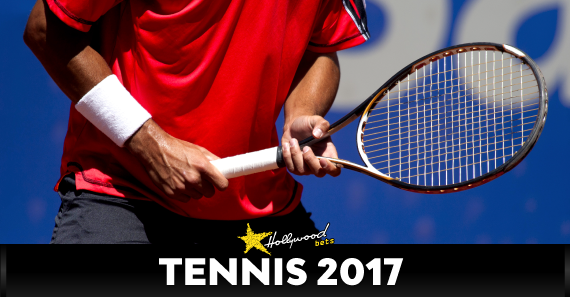 Tennis Player Holds Racquet 