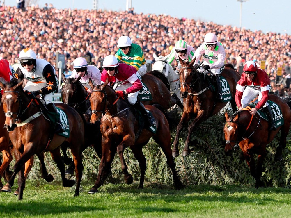 An image of the horses clearing a fence at the Grand National at Aintree in 2018.