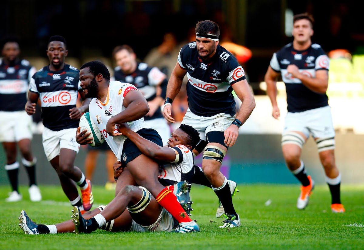 Phendulani Buthelezi of the Cell C Sharks looks to tackle Ox Nche of the Free State Cheetahs during the Currie Cup match between the Cell C Sharks and the Free State Cheetahs at Jonsson Kings Park Stadium in Durban