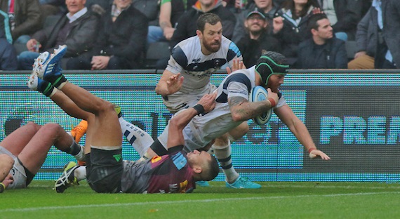 Jake Heenan of Bristol powers over Joe Marchant of Harlequins to score a try