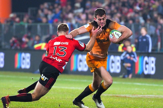 Emiliano Boffelli hands off a Crusaders player