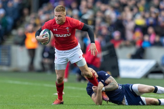 Gareth Anscombe of Wales is tackled by a Scottish defender. 