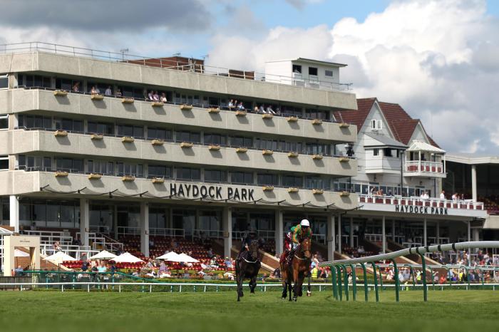 Runners and riders pass the grandstand during the Join Racing TV Now Handicap at Haydock Park Racecourse in Newton-le-Willows, Merseyside. Picture date: Wednesday June 9, 2021.