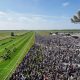 Racegoers watch Blackrod ridden by jockey Connor Beasley win the My Odds Boost On Betfair Handicap on day two of the QIPCO Guineas Festival at Newmarket Racecourse, Newmarket. Picture date: Saturday April 30, 2022.