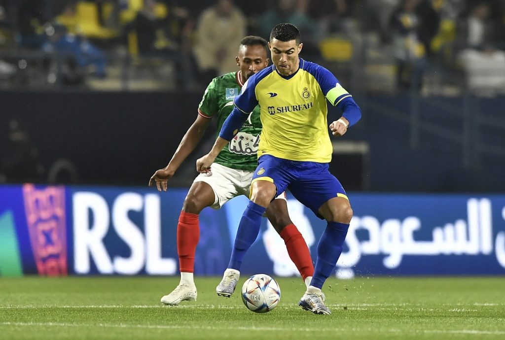 Al Nassr's Cristiano Ronaldo (R) in action against Al Ettifaq's Saeed Al Mowalad