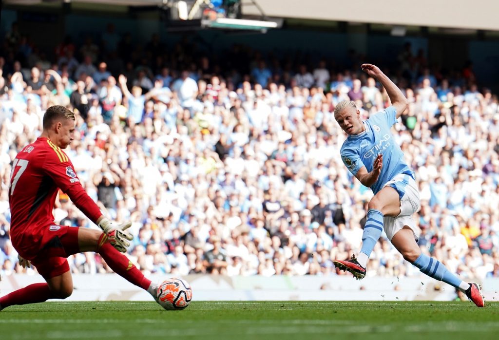 Manchester City's Erling Haaland (right) scores
