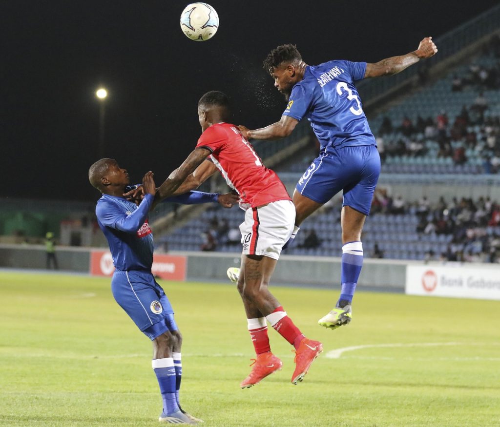 Thulani Hlatshwayo of Supersport United wins header against Tshepo Maikano of Gaborone United