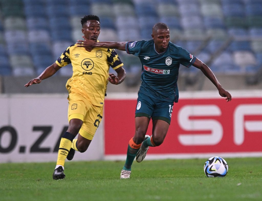 Thabo Nodada of Cape Town City challenges Tshepang Moremi of AmaZulu FC