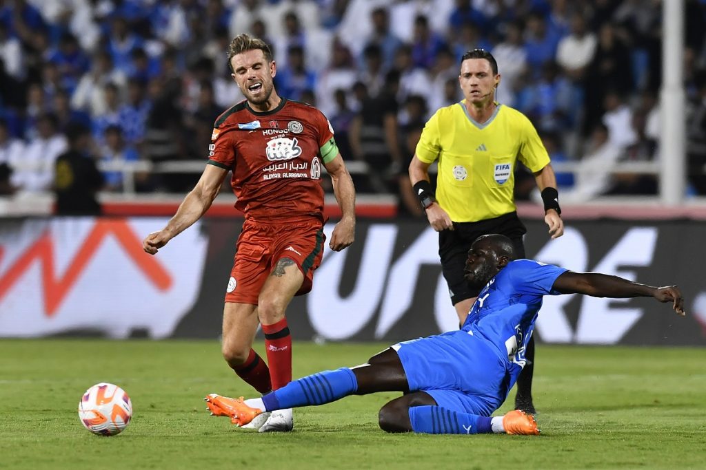 Al Hilal player Kalidou Koulibaly (R) tackles on Al Ittifaq player Jordan Henderson