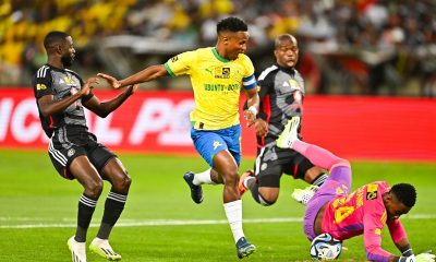 Close call for Tebogo Tlolane of Orlando Pirates as Themba Zwane, Captain of Mamelodi Sundowns nearly gets past his defence and that of Deon Hotto of Orlando Pirates