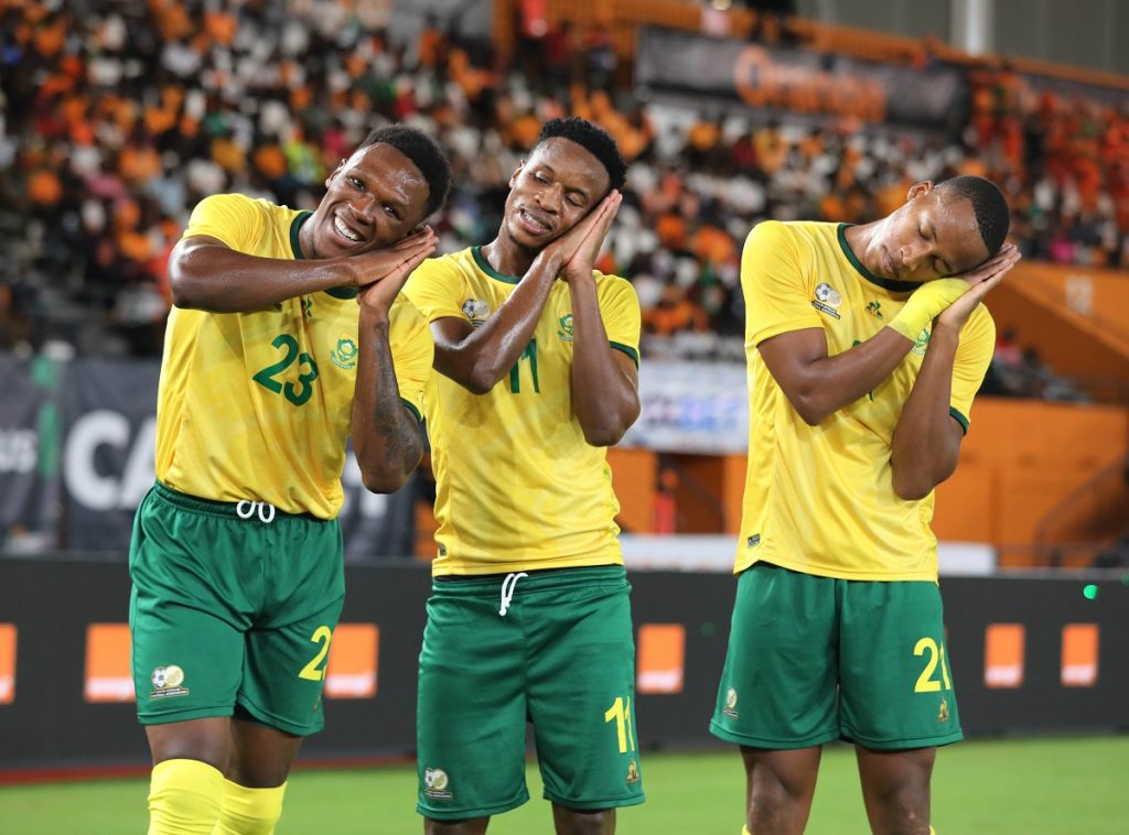 Themba Zwane of South Africa (c) celebrates goal with Lebo Mothiba (l) and Mihlali Mayambela (r)