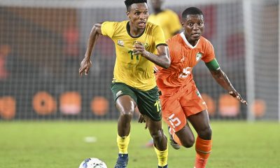Themba Zwane of South Africa is challenged by Max Gradel of Ivory Coast