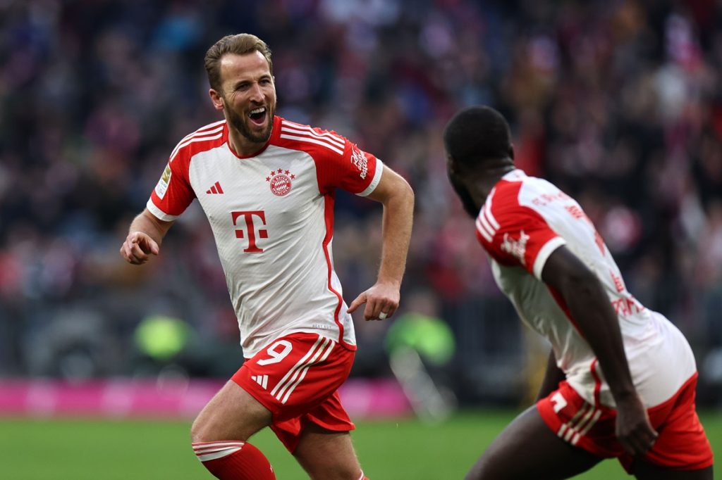 Munich's Harry Kane (L) celebrates with teammate Munich's Dayot Upamecano