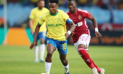 Themba Zwane of Mamelodi Sundowns challenged by Aliou Dieng of Al Ahly