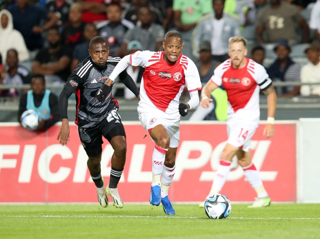 Luvuyo Phewa of Cape Town Spurs challenged by Bandile Shandu of Orlando Pirates