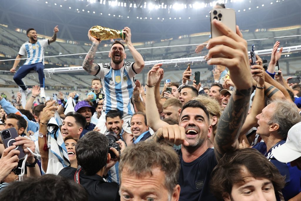 Lionel Messi of Argentina lifts the trophy as he celebrates with teammates after the FIFA World Cup 2022 Final.