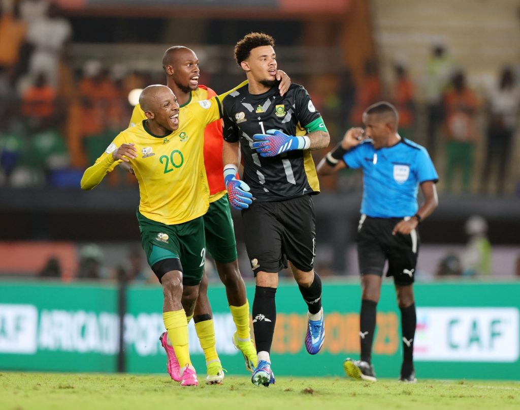 Ronwen Williams of South Africa celebrates with teammates after saving penalty during the 2023 Africa Cup of Nations 3rd place match between South Africa and DR Congo at Felix Houphouet Boigny Stadium.