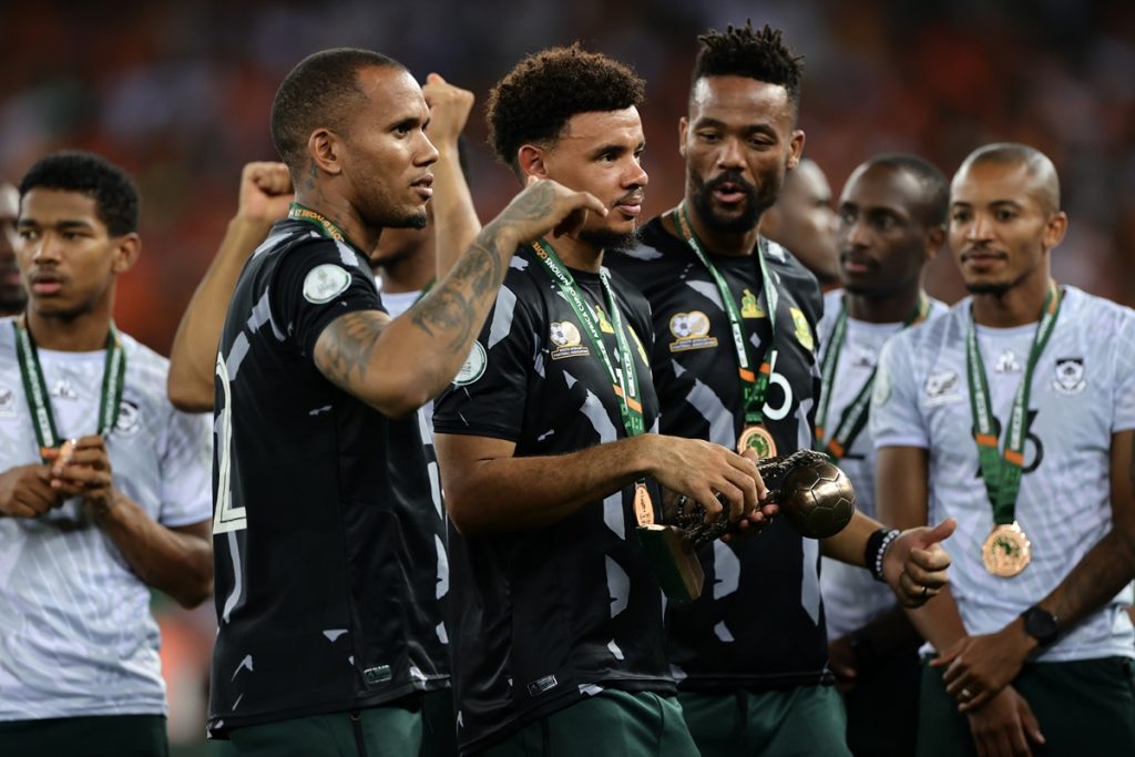 South Africa goalkeepers Ricardo Goss and Veli Mothwa celebrate Ecobank Best Goalkeeper Ronwen Williams during the 2023 Africa Cup of Nations final match between Nigeria and Cote dIvoire at Alassane Ouattara Stadium.