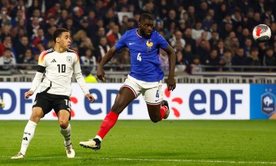 epa11239943 Jamal Musiala (L) of Germany in action against Dayot Upamecano (C) of France during the friendly international soccer match between France and Germany, in Decines-Charpieu, near Lyon, France, 23 March 2024.