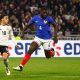 epa11239943 Jamal Musiala (L) of Germany in action against Dayot Upamecano (C) of France during the friendly international soccer match between France and Germany, in Decines-Charpieu, near Lyon, France, 23 March 2024.