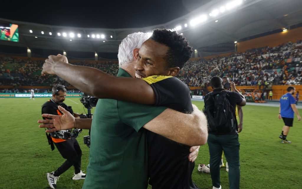 Hugo Broos, head coach of South Africa and Themba Zwane of South Africa celebrates victory during the 2023 Africa Cup of Nations 3rd Place Play Off between South Africa and DR Congo at the Felix Houphouet Boigny Stadium.