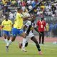 Grant Kekana of Mamelodi Sundowns challenged by Fily Traore of TP Mazembe during the 2023/24 CAF Champions League Group match between Sundowns and TP Mazembe at the Lucas Moripe Stadium