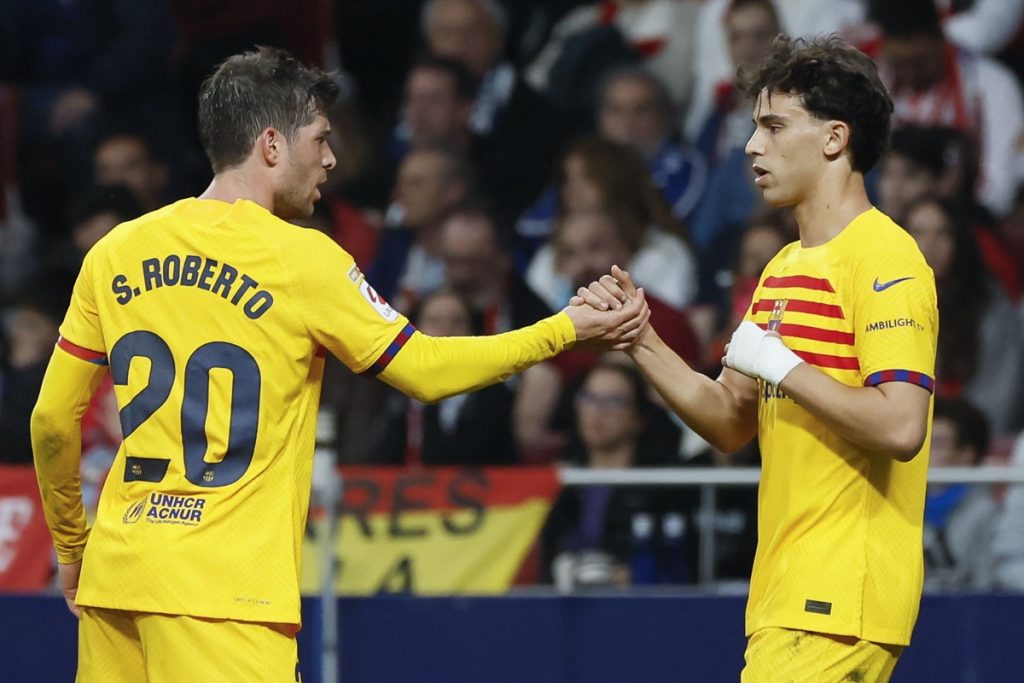 FC Barcelona's Joao Felix (R) celebrates with his teammate Sergio Roberto after scoring the 0-1 goal during the Spanish LaLiga soccer match between Atletico Madrid and FC Barcelona in Madrid