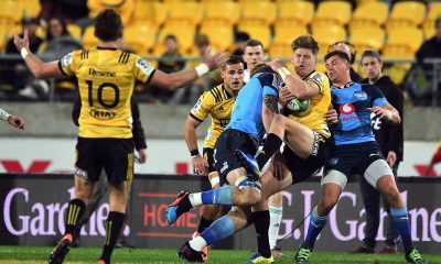 Hurricanes' Jordie Barrett grabs a high ball only to be tackled by Bulls RG Snyman during the 2019 Investec Super Rugby Quarterfinal game between Hurricanes vs Bulls, Westpac Stadium.