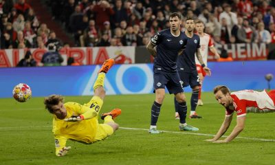 Munich's Harry Kane (R) scores the 1-0 goal against Lazio's goalkeeper Ivan Provedel (L) during the UEFA Champions League round of sixteen second leg match between FC Bayern Munich and SS Lazio.