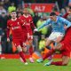 Liverpool's Virgil van Dijk challenges Manchester City's Phil Foden during the Premier League match at Anfield.