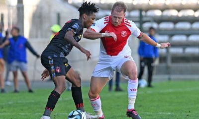 Puso Dithejane of TS Galaxy is challenged by Michael Morton of Cape Town Spurs during the DStv Premiership 2023/24 football match between Cape Town Spurs and TS Galaxy at Athlone Stadium.