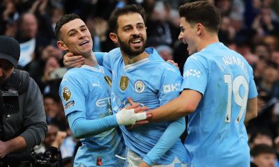 Phil Foden (L) of Manchester City celebrates with teammate Bernado Silva (C) and Julián Álvarez (R) after scoring his team's second goal during the English Premier League match between Manchester City and Manchester United, at the Etihad Stadium.