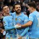 Phil Foden (L) of Manchester City celebrates with teammate Bernado Silva (C) and Julián Álvarez (R) after scoring his team's second goal during the English Premier League match between Manchester City and Manchester United, at the Etihad Stadium.
