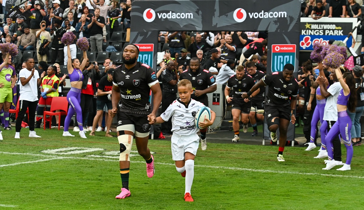 Lukhanyo Am, captain of Hollywoodbets Sharks leads his team onto the field during the 2024 United Rugby Championship 2023/24 game between the Sharks and Stormers at Kings Park Stadium.