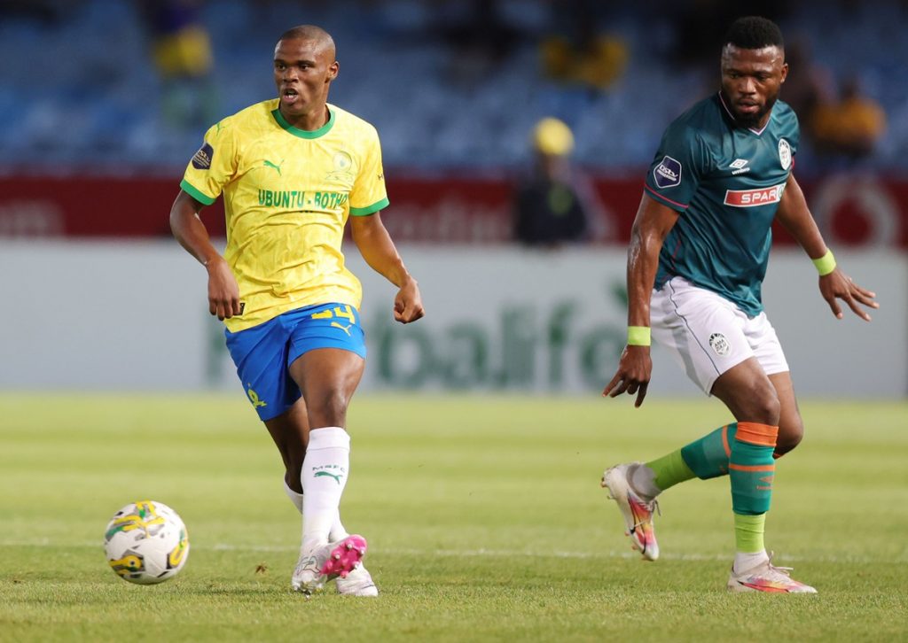 Zuko Mdunyelwa of Mamelodi Sundowns challenged by Augustine Kwem of AmaZulu FC during the DStv Premiership 2023/24 match at Loftus Versfeld Stadium.