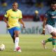 Zuko Mdunyelwa of Mamelodi Sundowns challenged by Augustine Kwem of AmaZulu FC during the DStv Premiership 2023/24 match at Loftus Versfeld Stadium.