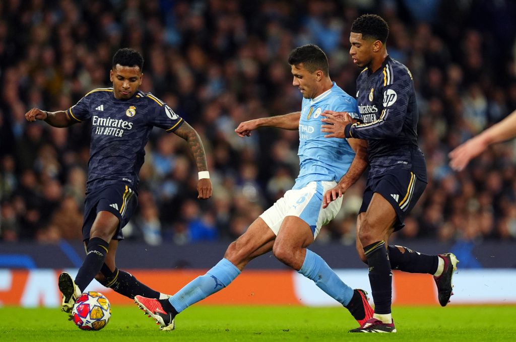 Manchester City's Rodri (centre) is challenged by Real Madrid's Jude Bellingham and Rodrygo (left) during the UEFA Champions League quarter-final, second leg match at the Etihad Stadium, Manchester.