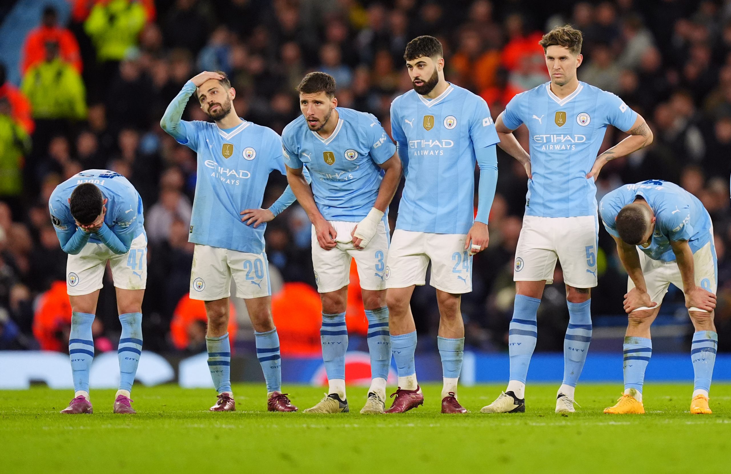 Manchester City players look on dejected during the penalty shoot out following the UEFA Champions League quarter-final, second leg match at the Etihad Stadium, Manchester.