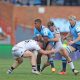 Canan Moodie of the Bulls challenged by Yanis Charcosset and Kyle Godwin of Lyon during the United Rugby Championship 2023/24 match between Bulls and Lyon at Loftus Stadium in Pretoria on 06 April 2024