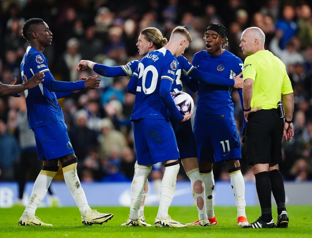 Chelsea's Cole Palmer holds onto the ball as Chelsea player discuss who will take the penalty during the Premier League match at Stamford Bridge, London. Picture date: Monday April 15, 2024.