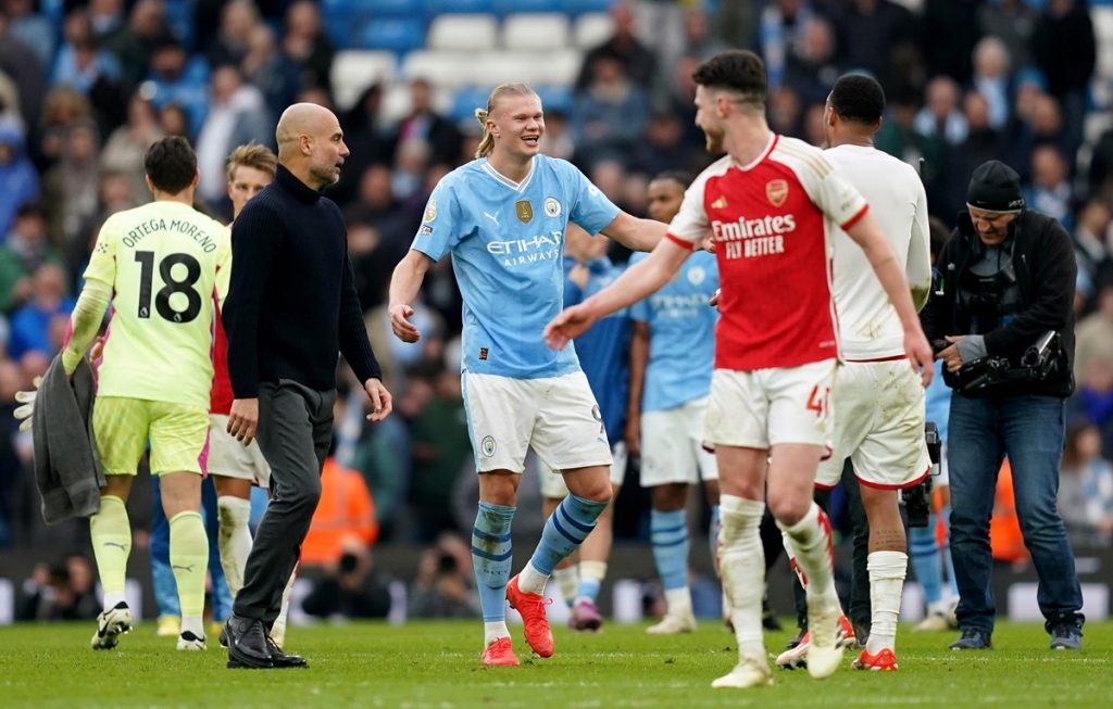 Manchester City manager Pep Guardiola and Erling Haaland speaks with Arsenal's Declan Rice and Gabriel following the Premier League match at the Etihad Stadium.