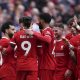 Mohamed Salah (L) of Liverpool celebrates with teammates after scoring the 2-1 lead during the English Premier League match between Liverpool and Brighton.