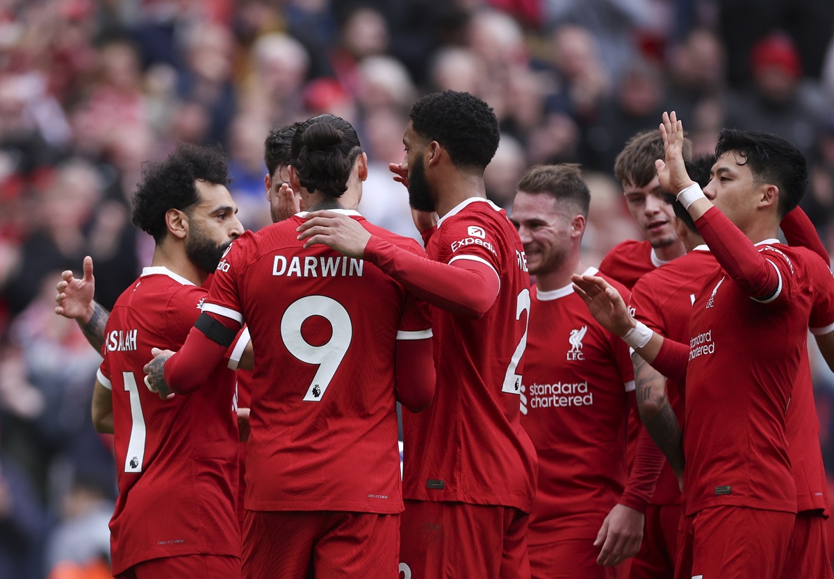 Mohamed Salah (L) of Liverpool celebrates with teammates after scoring the 2-1 lead during the English Premier League match between Liverpool and Brighton.