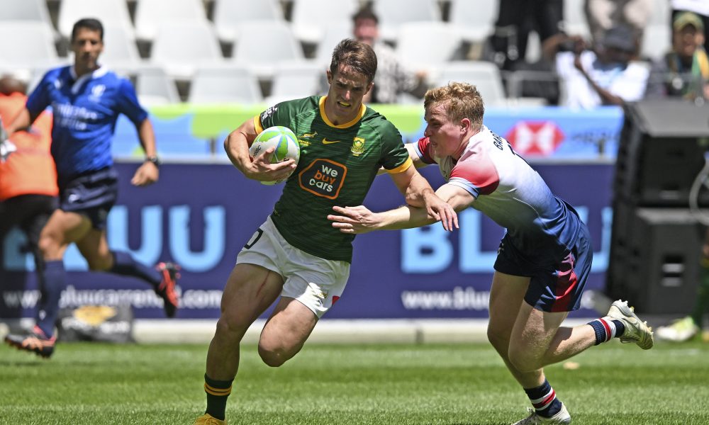 Quewin Nortje of South Africa scores a try despite the efforts of Jamie Barden of Great Britain during day one of the 2023 HSBC Cape Town Sevens at Cape Town Stadium on 9 December 2023
