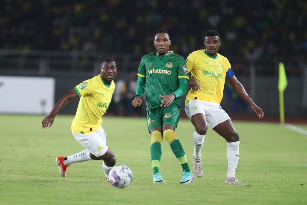 Teboho Mokoena of Sundowns challenges Clement Maize of Young Africans during the CAF Champions League 2023/24 quarterfinals 1st leg match between Young Africans and Mamelodi Sundowns at Benjamin Mkapa Stadium.