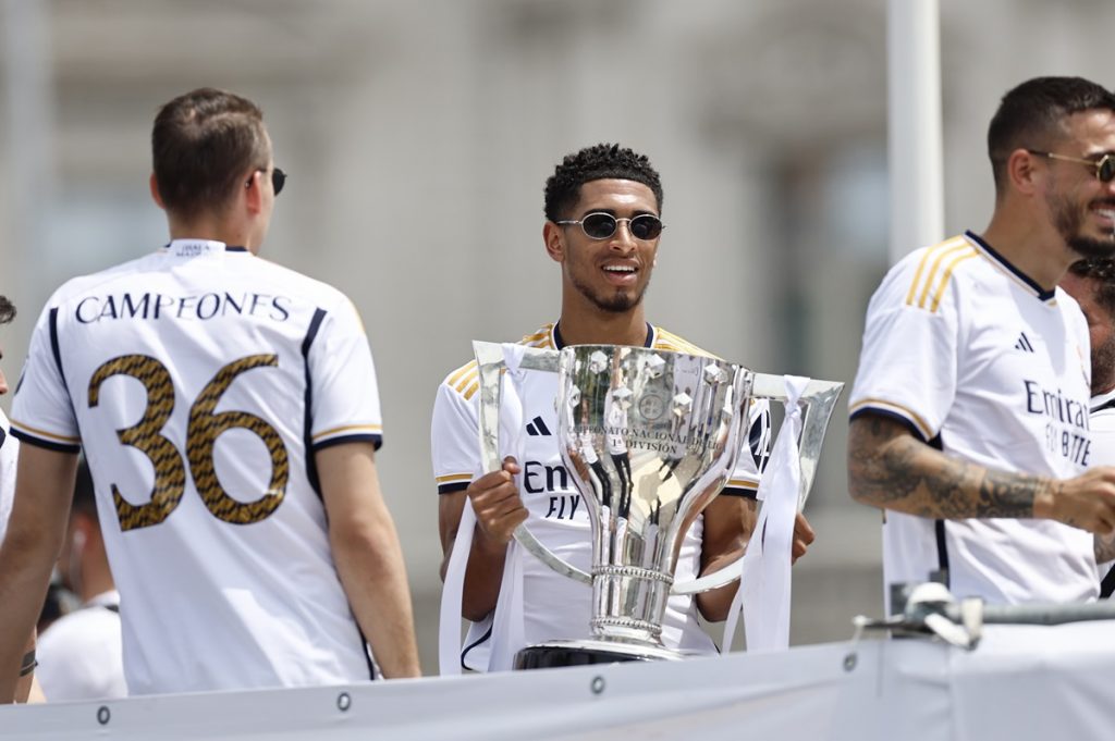Real Madrid's player Jude Bellingham (C) cheers during an open roof bus parade celebrating Real Madrid's LaLiga title in Madrid, Spain, 12 May 2024.