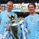 Manchester City's Erling Haaland (L) and Kevin De Bruyne (R) pose with the Premier League championship trophy, the fourth consecutive won by City, after the English Premier League soccer match of Manchester City against West Ham United, in Manchester.