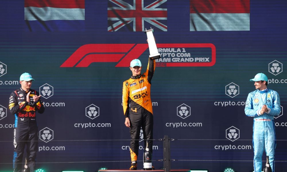 First place McLaren driver Lando Norris of Britain (C) holds up his trophy as second place Red Bull Racing driver Max Verstappen of Netherlands (L) and Scuderia Ferrari driver Charles Leclerc of Monaco (R) applaud on the winners podium in the Formula 1 Miami Grand Prix, at the Miami International Autodrome.