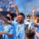 Manchester City's players celebrate as captain Kyle Walker (C) lifts the Premier League championship trophy, the fourth consecutive won by City, after the English Premier League soccer match of Manchester City against West Ham United, in Manchester.