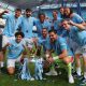 Manchester City players pose with the Premier League championship trophy, the fourth consecutive won by City, after the English Premier League soccer match of Manchester City against West Ham United, in Manchester.
